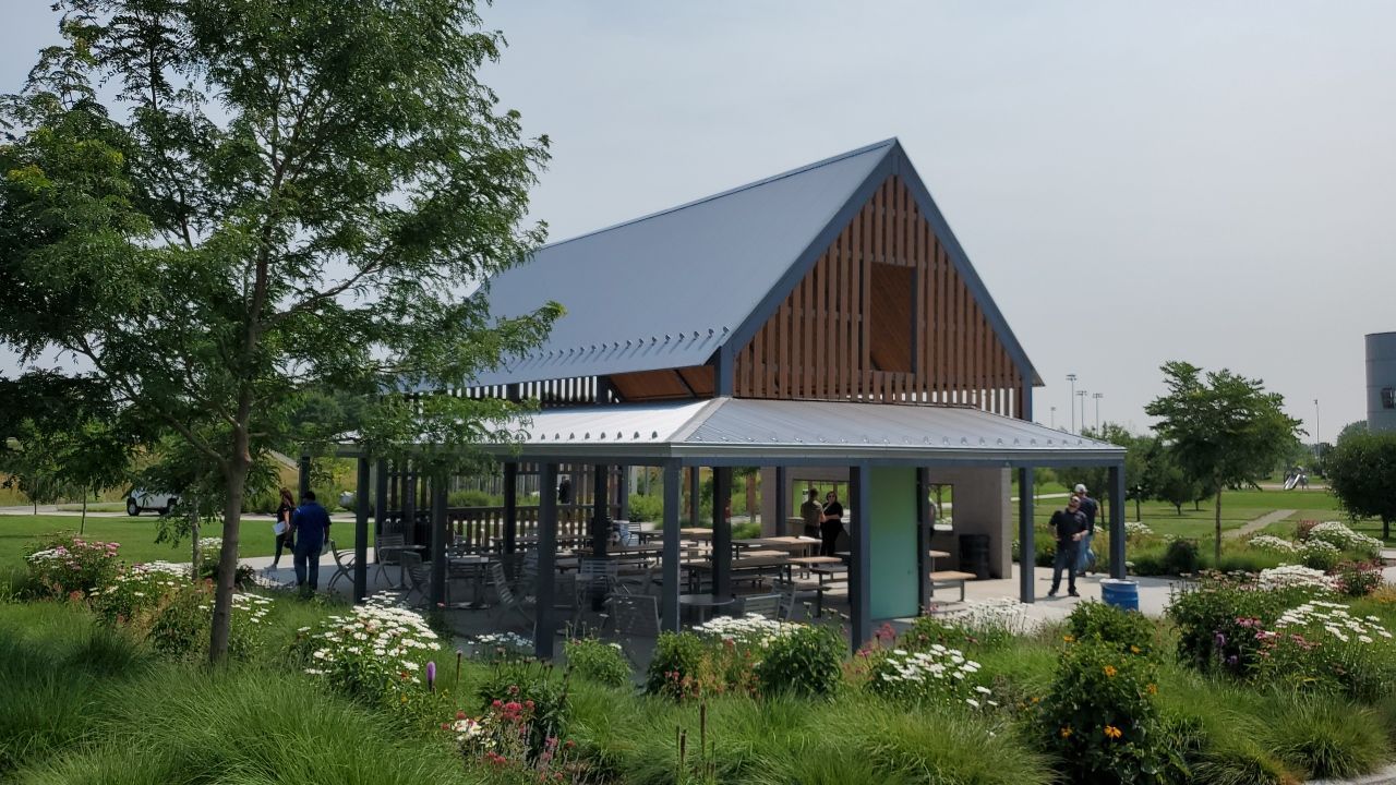 an outdoor picnic area with a metal roof