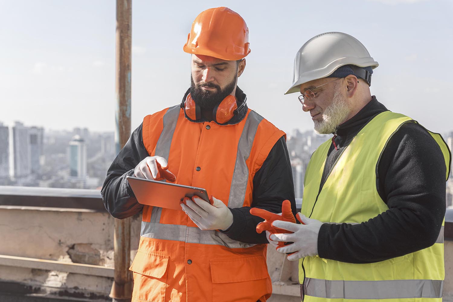 two construction workers viewing a tablet